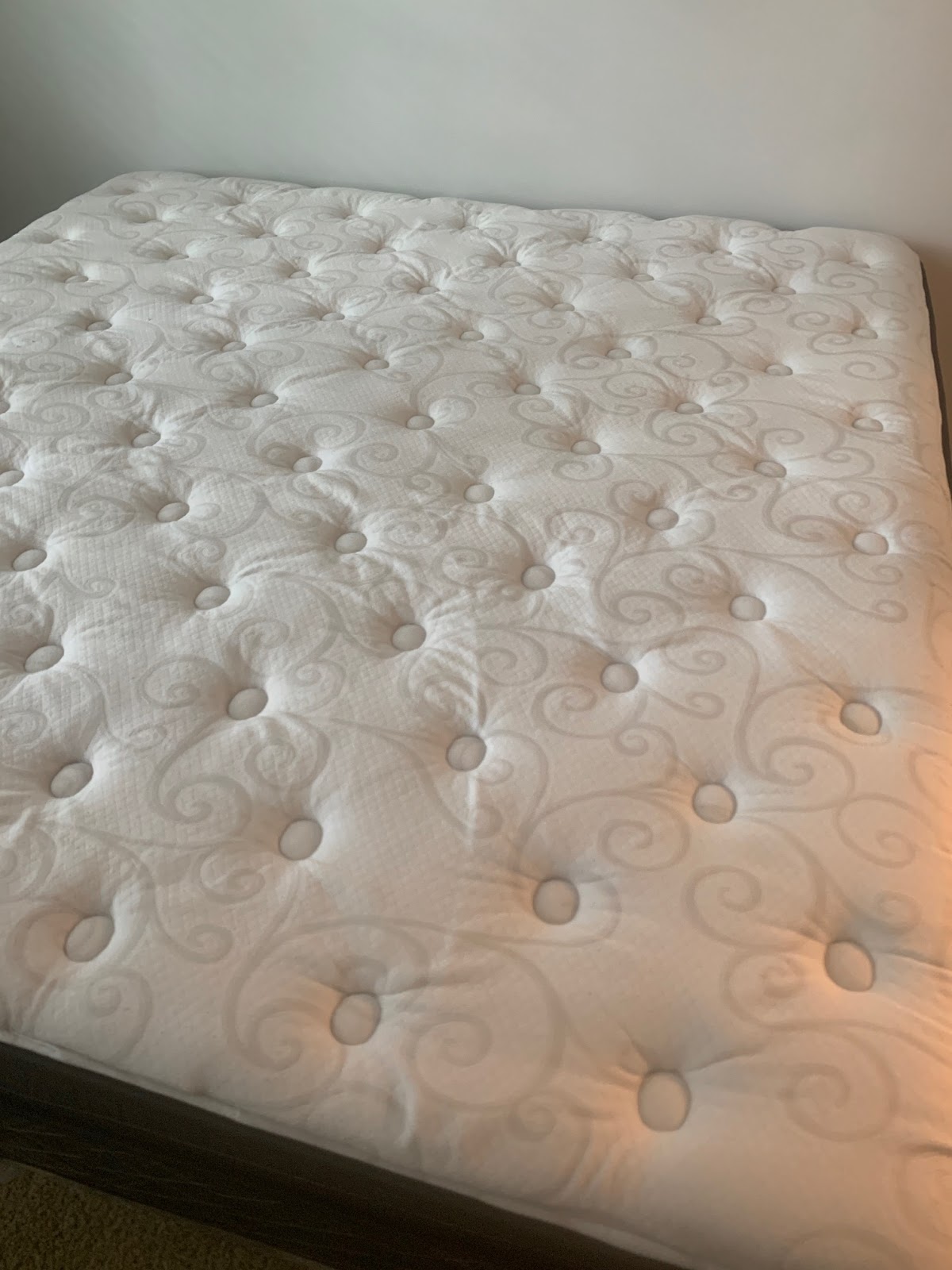 Dream Steam — close-up of a pillow-top queen mattress with tufted swirl pattern after a deep steam clean and sanitize